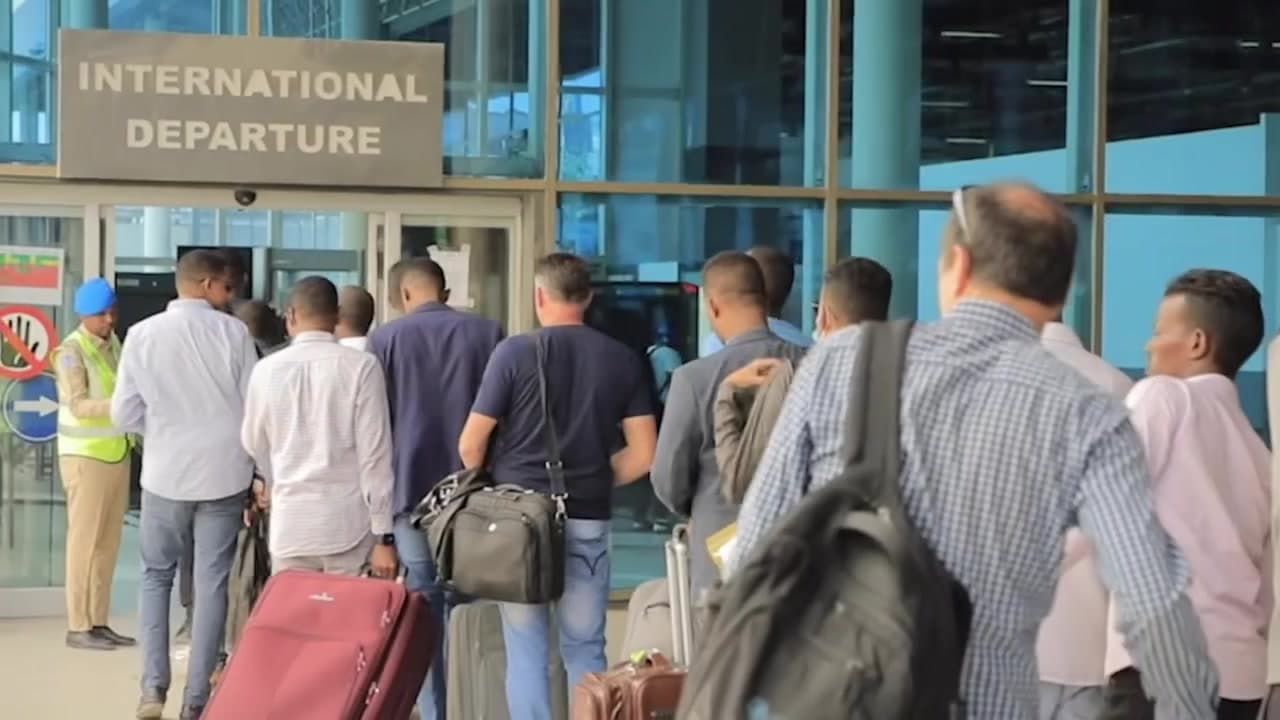 Passengers at the international departures entrance